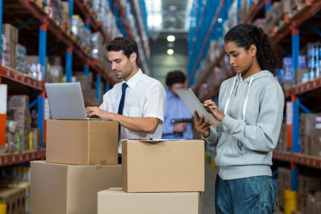 How a Local Warehouse Distribution Business Helps Serve More Customers concentrate worker typing on laptop and digital tablet in warehouse