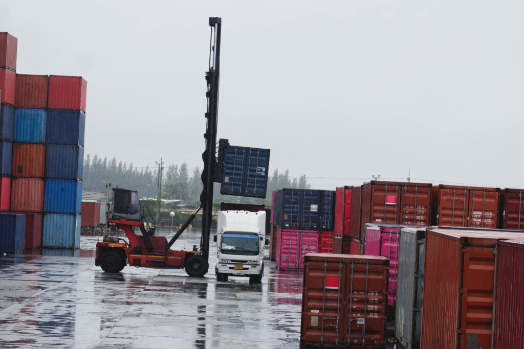 container forklift moving containers into trucks