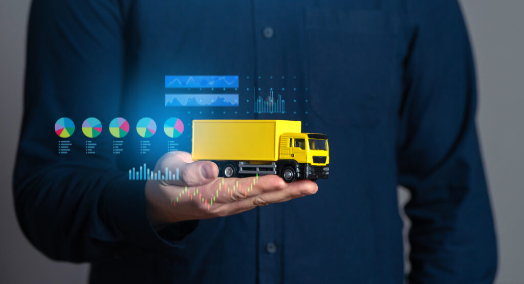 How Structured Delivery Management Accelerates Growth businessman holding a truck and economic charts. logistics industry. transport optimization. selection of delivery methods, effective number of vehicles and crews.