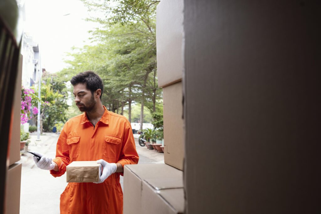 young delivery man checking information about parcel