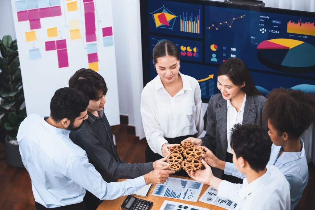 Why Brands With Strong Operations Influence Markets office worker holding cog wheel as unity and teamwork in workplace. concord